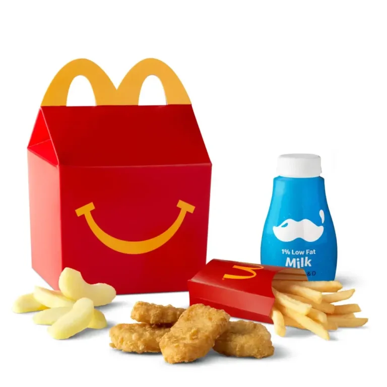 A 4 Piece Chicken McNuggets® Happy Meal® served with fries, apple slices, and a drink.