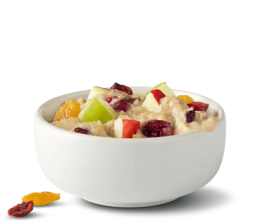 A warm oatmeal made with diced apples, cranberries, and two kinds of raisins for a wholesome breakfast.