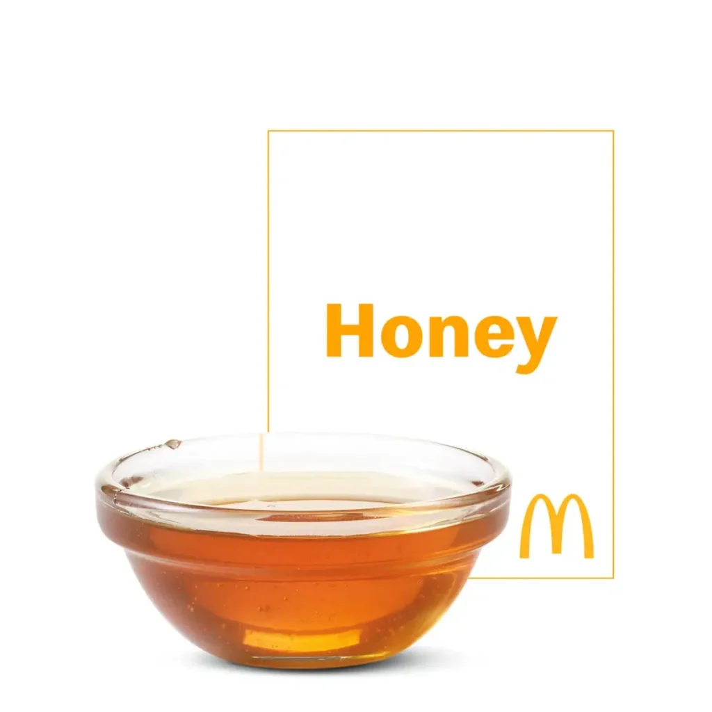 A packet of McDonald's Honey, perfect for adding a touch of sweetness to your meal or dipping.