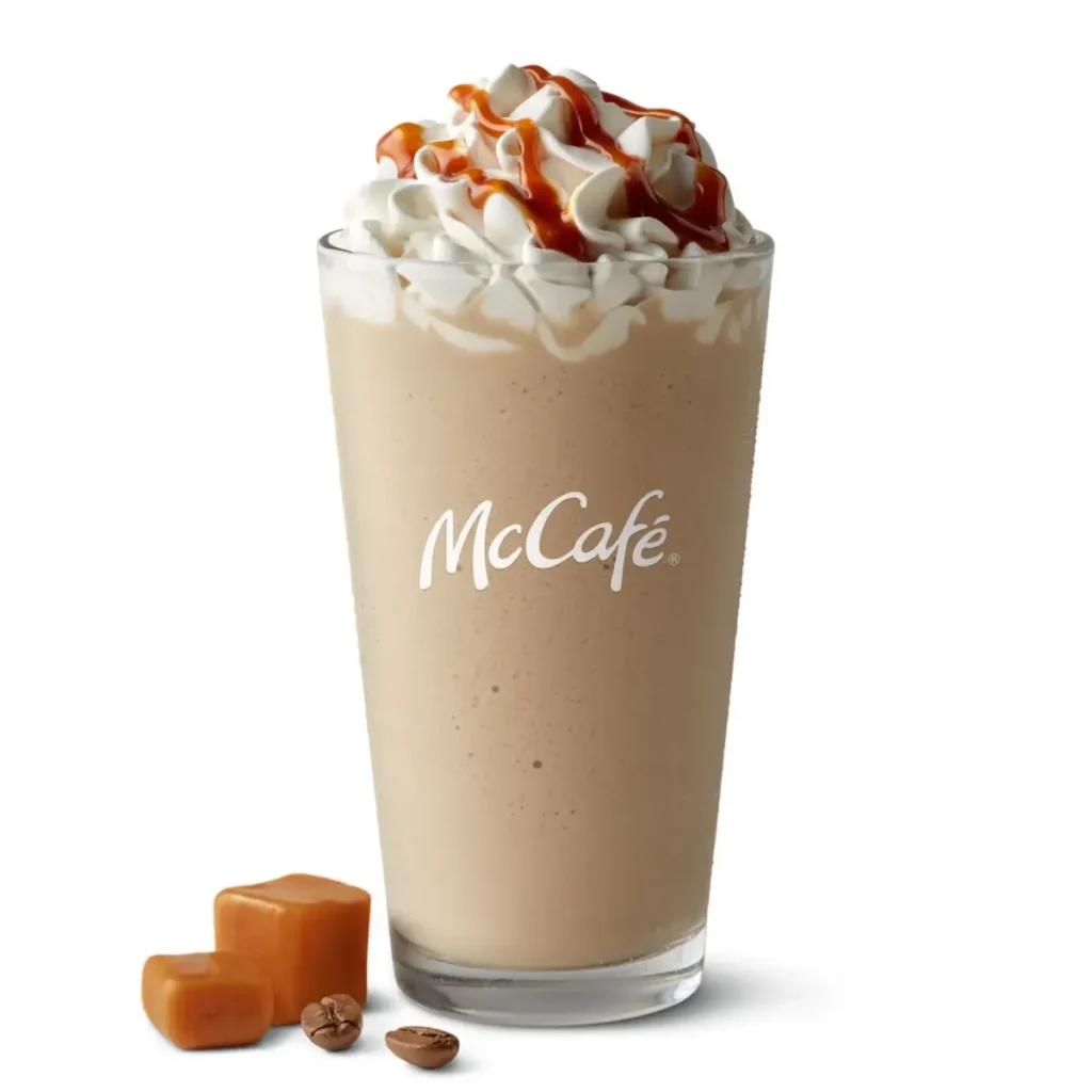 A McCafé® Caramel Frappé, a blended ice drink with caramel flavor, topped with whipped cream and caramel drizzle.