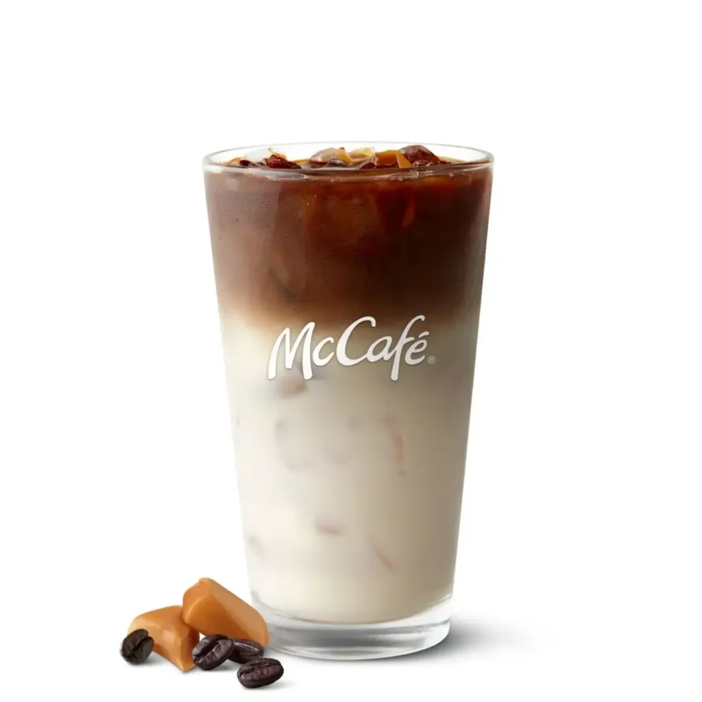 A McCafé® Iced Caramel Macchiato, cold espresso mixed with milk and caramel drizzle, served over ice.