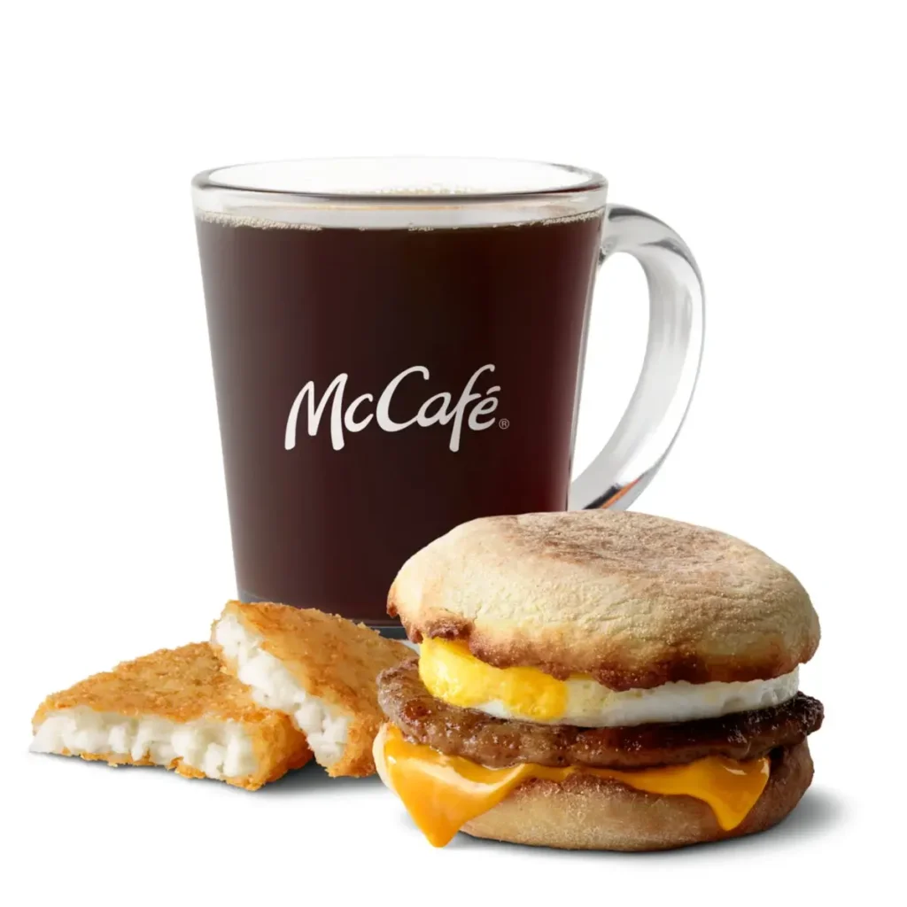 A Sausage McMuffin® with Egg served with crispy hash browns and a drink for a satisfying meal.